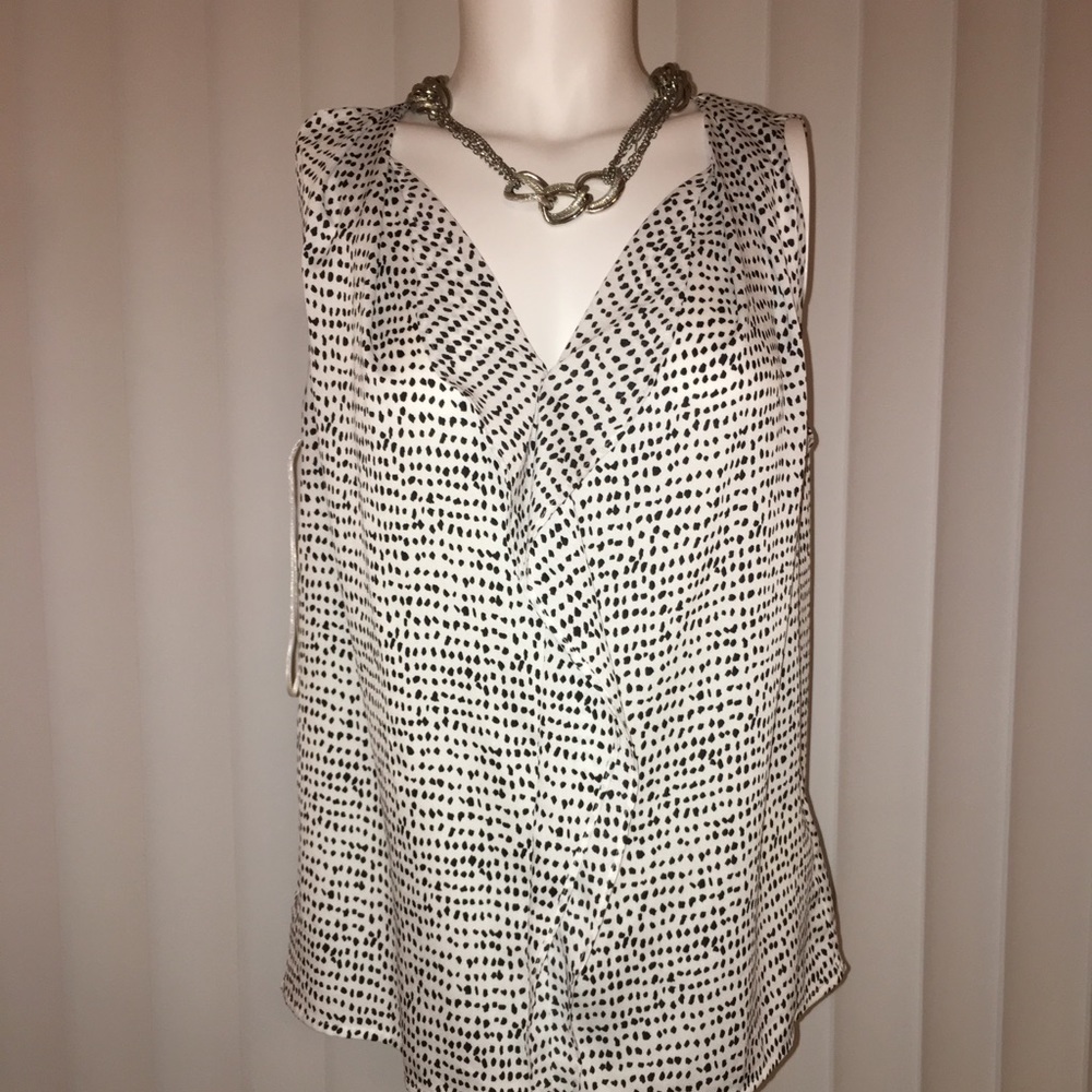 ANN TAYLOR BLOUSE WITH RUFFLE ON THE FRONT. CUTE AND COMFORTABLE. LIKE NEW.